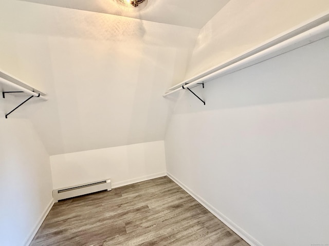 249 Wall St, Hebron, CT 06248 - walk in closet with baseboard heating, wood finished floors, and vaulted ceiling