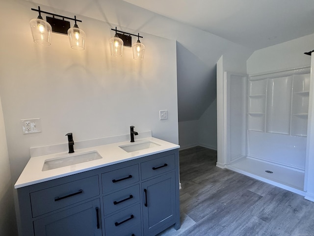 249 Wall St, Hebron, CT 06248 - full bath featuring wood finished floors, double vanity, a shower, and lofted ceiling