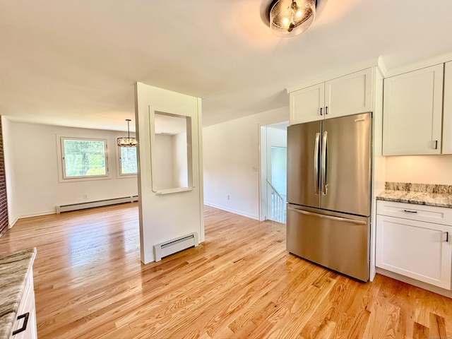 249 Wall St, Hebron, CT 06248 - kitchen with stainless steel fridge, a baseboard radiator, and white cabinets