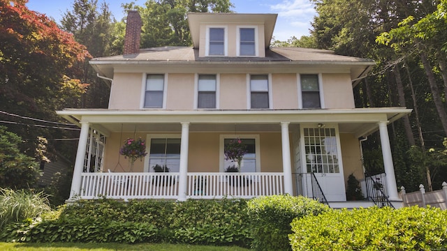 29 Circuit Ave, Waterbury, CT 06708 - view of front of home with stucco siding, covered porch, and a chimney