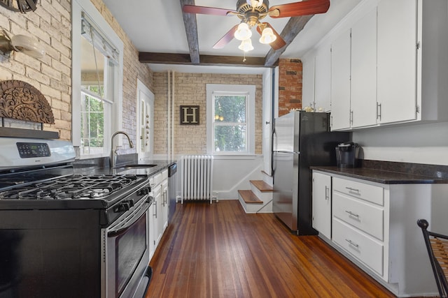 29 Circuit Ave, Waterbury, CT 06708 - kitchen with stainless steel appliances, radiator heating unit, brick wall, dark wood finished floors, and beamed ceiling
