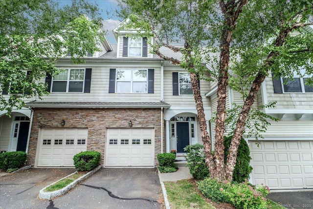 6 Faith Ln Unit 6, Danbury, CT 06810 - view of front of property featuring a garage, driveway, and stone siding