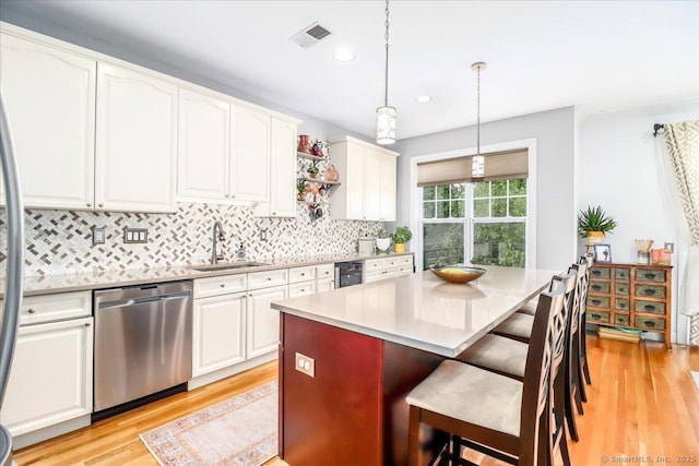 6 Faith Ln Unit 6, Danbury, CT 06810 - kitchen featuring dishwasher, light wood finished floors, decorative backsplash, white cabinets, and a breakfast bar area