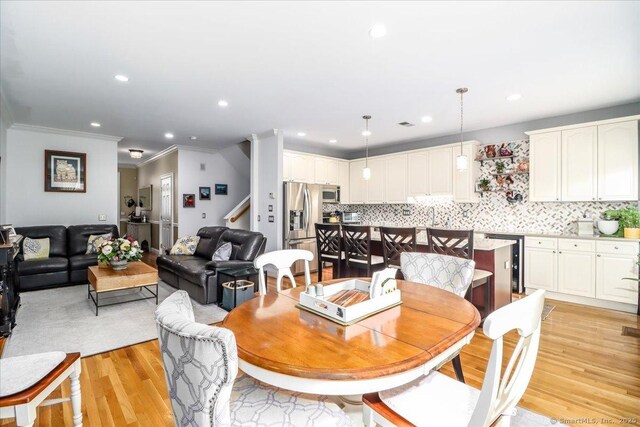 6 Faith Ln Unit 6, Danbury, CT 06810 - dining space featuring ornamental molding, light wood-type flooring, stairs, and recessed lighting