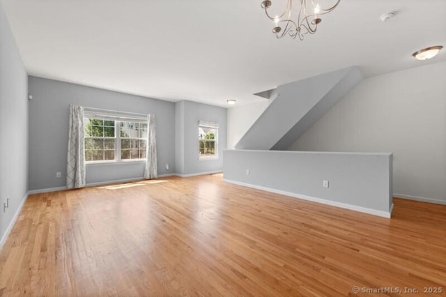 3 Riverview Ct Unit 3, Brookfield, CT 06804 - unfurnished living room with wood finished floors and a chandelier