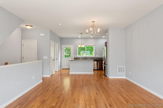 3 Riverview Ct Unit 3, Brookfield, CT 06804 - unfurnished living room featuring a chandelier and light wood-style flooring