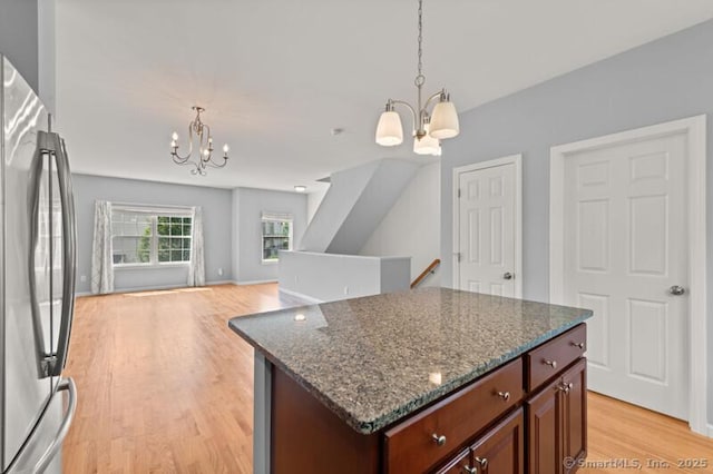3 Riverview Ct Unit 3, Brookfield, CT 06804 - kitchen with a chandelier, freestanding refrigerator, light wood finished floors, dark stone countertops, and hanging light fixtures