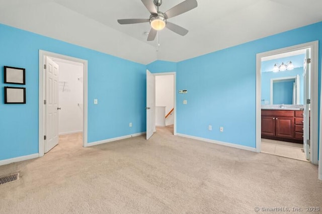 3 Riverview Ct Unit 3, Brookfield, CT 06804 - unfurnished bedroom with light colored carpet, a walk in closet, ensuite bathroom, vaulted ceiling, and ceiling fan