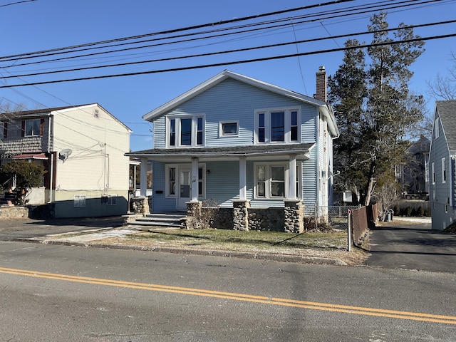 140 Stuart Ave, Norwalk, CT 06850 - view of front facade featuring a chimney and covered porch