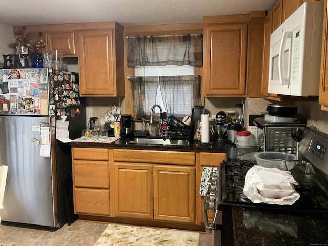 140 Stuart Ave, Norwalk, CT 06850 - kitchen featuring stainless steel appliances, dark countertops, and brown cabinets