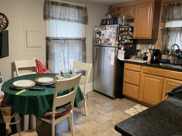 140 Stuart Ave, Norwalk, CT 06850 - kitchen with freestanding refrigerator, light stone finish floors, and healthy amount of natural light