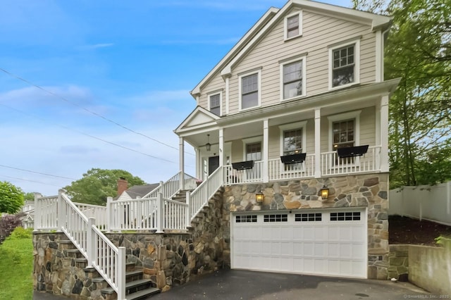 109 W Ave, Darien, CT 06820 - view of front of property featuring stairway, a porch, an attached garage, and asphalt driveway