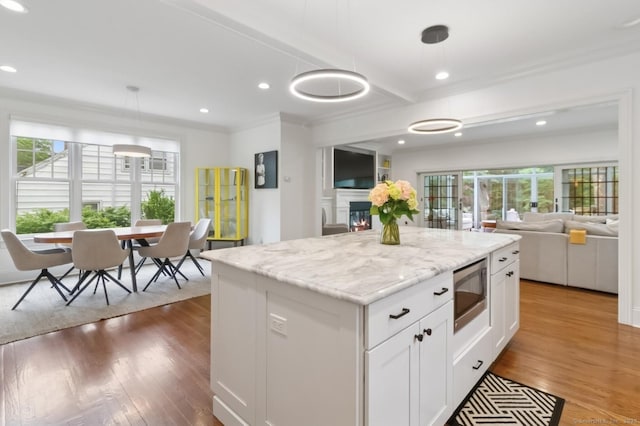 109 W Ave, Darien, CT 06820 - kitchen with stainless steel microwave, open floor plan, healthy amount of natural light, wood finished floors, and recessed lighting