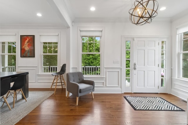 109 W Ave, Darien, CT 06820 - entrance foyer with plenty of natural light, a chandelier, a decorative wall, wood finished floors, and crown molding