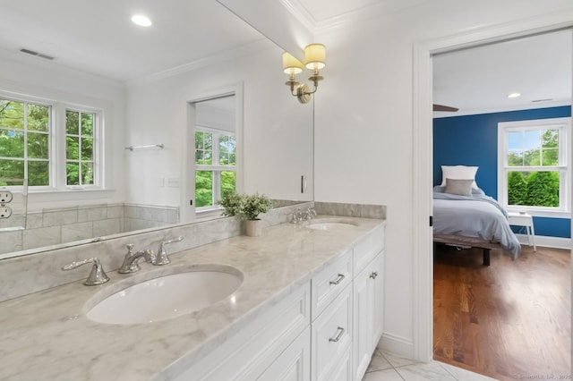 109 W Ave, Darien, CT 06820 - ensuite bathroom with ornamental molding, double vanity, healthy amount of natural light, and recessed lighting
