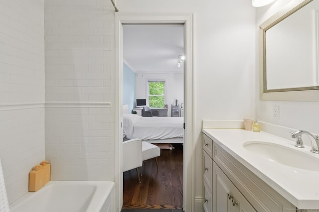 109 W Ave, Darien, CT 06820 - ensuite bathroom with wood finished floors, vanity, and tub / shower combination