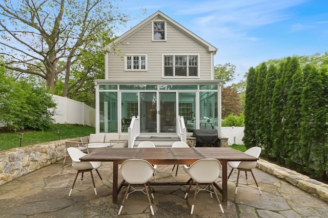 109 W Ave, Darien, CT 06820 - rear view of property with a sunroom, a patio, outdoor dining area, and a fenced backyard