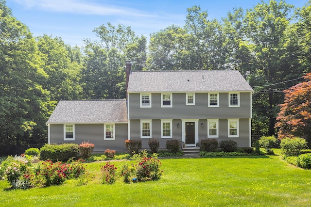 97 Wildwood Cir, Durham, CT 06422 - colonial home featuring a chimney, a front lawn, and roof with shingles