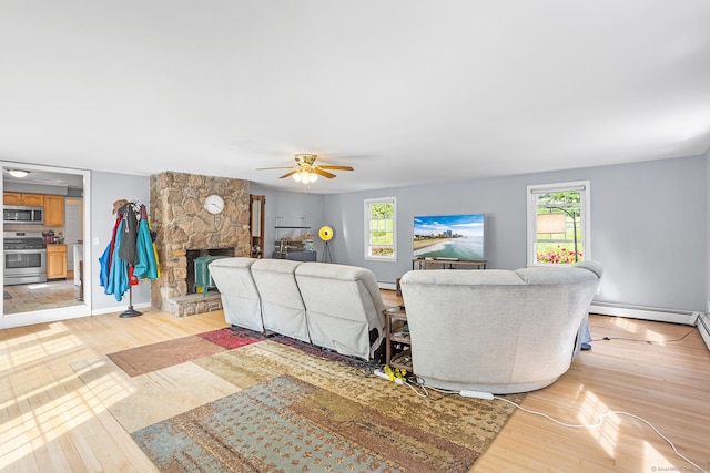 97 Wildwood Cir, Durham, CT 06422 - living room with light wood-style flooring, a fireplace, a baseboard heating unit, and a ceiling fan