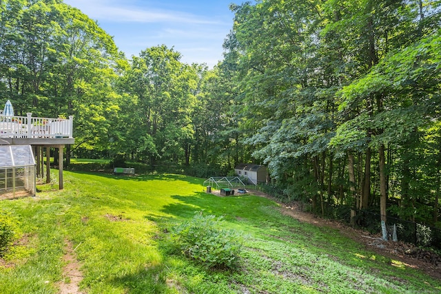 97 Wildwood Cir, Durham, CT 06422 - view of grassy yard with a greenhouse, a storage unit, and a wooden deck