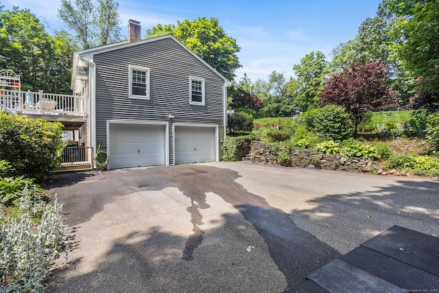 97 Wildwood Cir, Durham, CT 06422 - view of property exterior with a chimney, a garage, and driveway