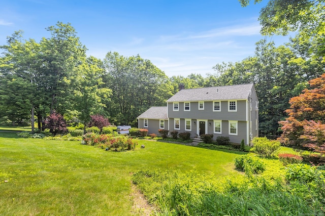 97 Wildwood Cir, Durham, CT 06422 - colonial-style house featuring a chimney, a front lawn, and a shingled roof