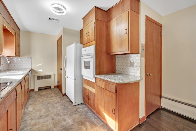 165 Douglas St, Stratford, CT 06614 - kitchen with white appliances, radiator heating unit, baseboard heating, decorative backsplash, and light stone countertops