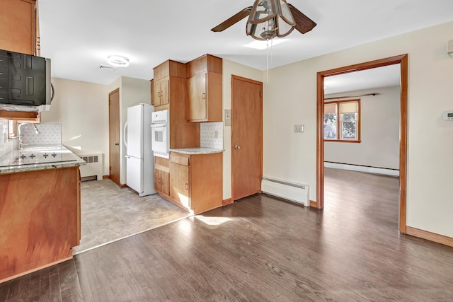 165 Douglas St, Stratford, CT 06614 - kitchen with white appliances, a ceiling fan, a baseboard heating unit, and light wood-style flooring