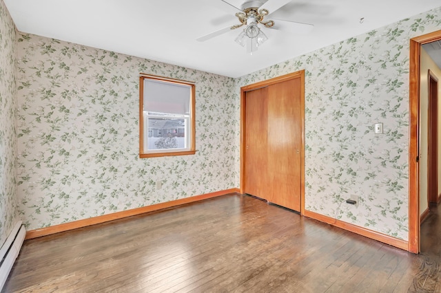 165 Douglas St, Stratford, CT 06614 - spare room featuring a baseboard radiator, wood-type flooring, a ceiling fan, and wallpapered walls