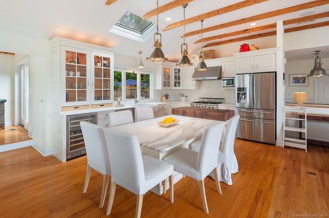 113 N Lake Shore Dr, Brookfield, CT 06804 - dining space with wine cooler, a skylight, recessed lighting, and light wood finished floors