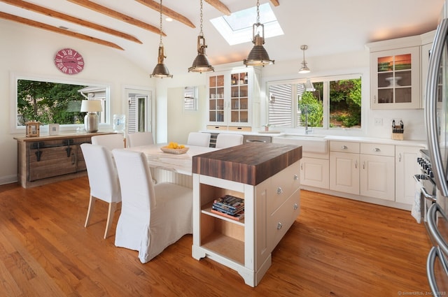 113 N Lake Shore Dr, Brookfield, CT 06804 - kitchen featuring butcher block countertops, a kitchen island, a skylight, and pendant lighting