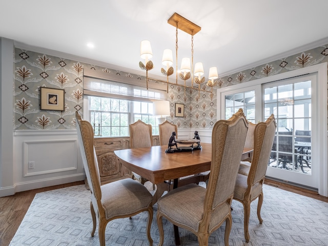 120 Prospect St Apt 63, Ridgefield, CT 06877 - dining area featuring wallpapered walls, crown molding, a chandelier, a wainscoted wall, and wood finished floors