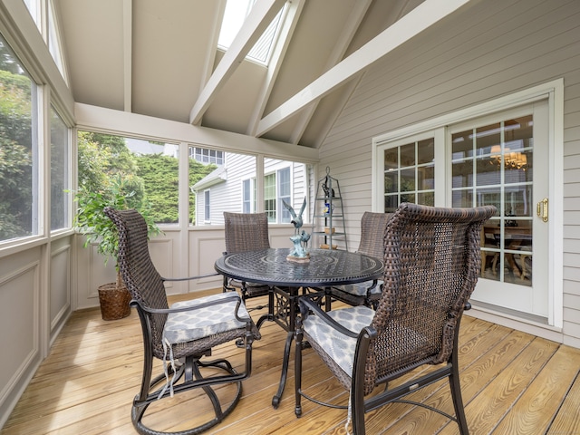 120 Prospect St Apt 63, Ridgefield, CT 06877 - sunroom / solarium featuring beam ceiling, wood finished floors, high vaulted ceiling, wood walls, and a decorative wall
