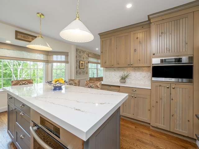 120 Prospect St Apt 63, Ridgefield, CT 06877 - kitchen featuring oven, light wood-type flooring, a kitchen island, hanging light fixtures, and recessed lighting
