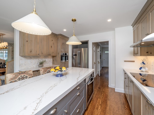 120 Prospect St Apt 63, Ridgefield, CT 06877 - kitchen featuring stainless steel appliances, dark wood finished floors, hanging light fixtures, decorative backsplash, and light stone countertops