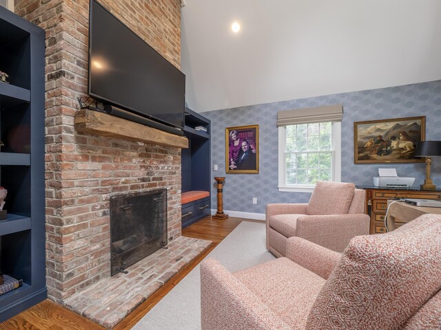 120 Prospect St Apt 63, Ridgefield, CT 06877 - living area featuring wallpapered walls, wood finished floors, a brick fireplace, and high vaulted ceiling