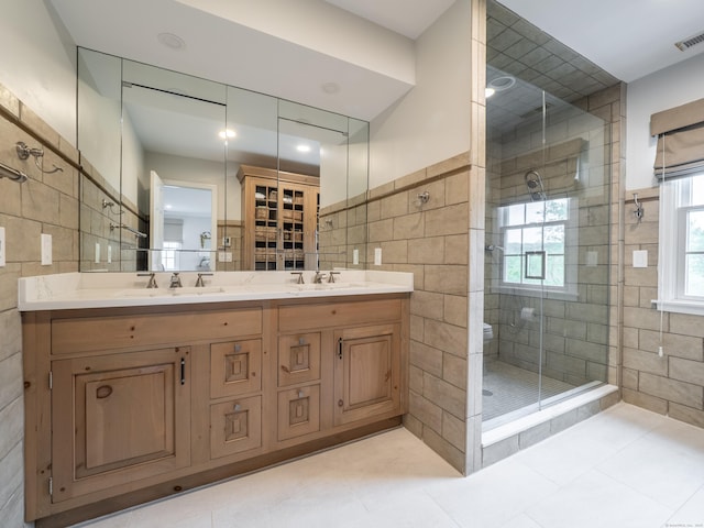 120 Prospect St Apt 63, Ridgefield, CT 06877 - full bathroom with tile walls, a shower stall, double vanity, tile patterned flooring, and recessed lighting