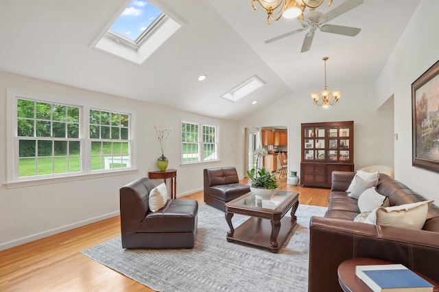 11 Scodon Dr, Ridgefield, CT 06877 - living area with a skylight, a chandelier, lofted ceiling, light wood finished floors, and a ceiling fan