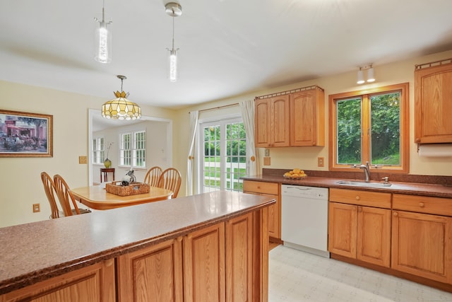 11 Scodon Dr, Ridgefield, CT 06877 - kitchen with white dishwasher, decorative light fixtures, dark countertops, and light floors