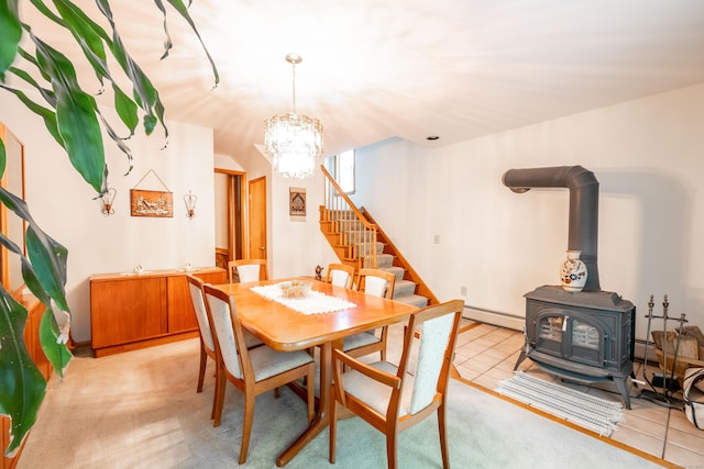 348 State Route 39, New Fairfield, CT 06812 - dining area with stairs, a baseboard heating unit, a wood stove, and a chandelier