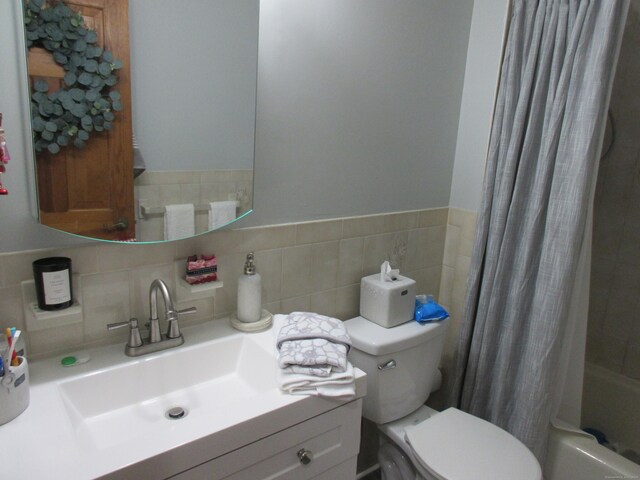75 Wheeler Ave Unit 205, Bridgeport, CT 06606 - bathroom featuring vanity, shower / bath combo with shower curtain, and decorative backsplash
