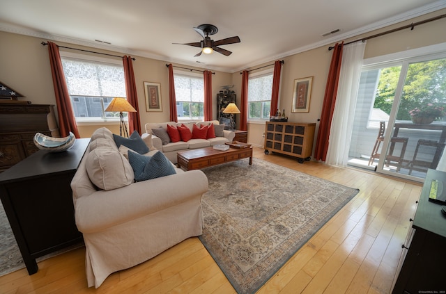 267 Melba St Apt B13, Milford, CT 06460 - living room with healthy amount of natural light, ornamental molding, ceiling fan, and light wood-style flooring