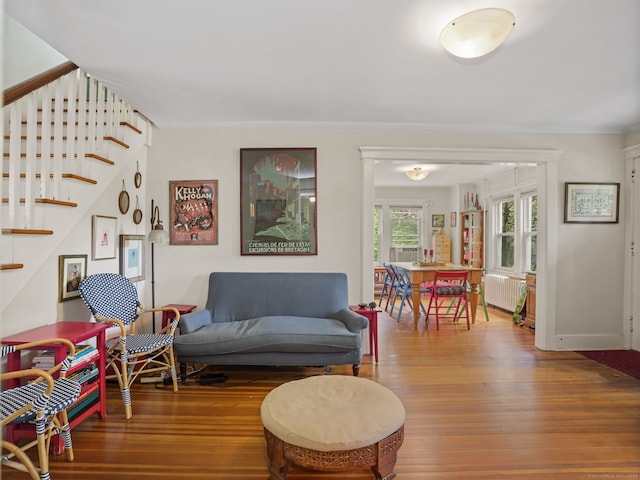 58 Riverdale Ave, Greenwich, CT 06831 - living area with radiator heating unit, stairs, wood finished floors, and crown molding