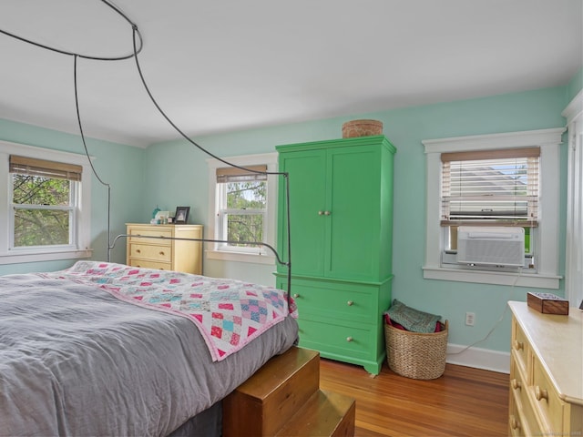58 Riverdale Ave, Greenwich, CT 06831 - bedroom featuring wood finished floors, multiple windows, and cooling unit