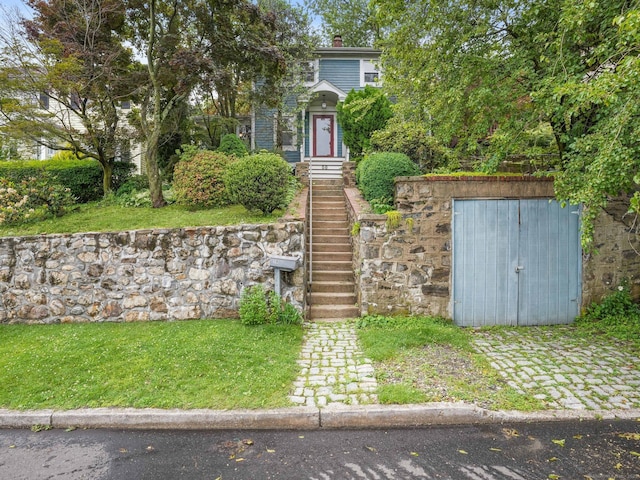 58 Riverdale Ave, Greenwich, CT 06831 - view of front of property featuring a storage shed and a front lawn