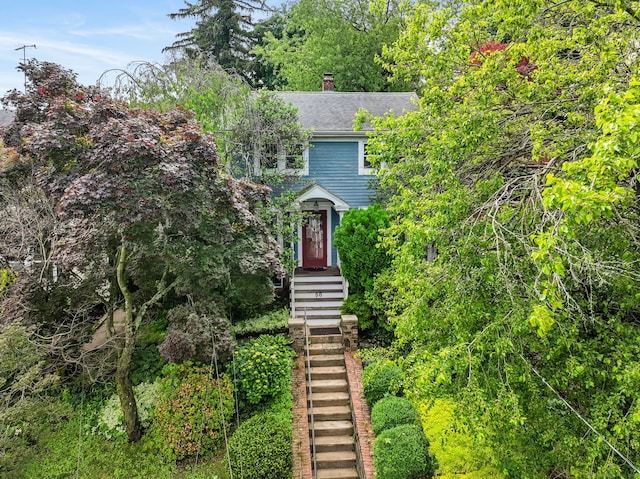 58 Riverdale Ave, Greenwich, CT 06831 - view of front of home with a chimney, a shingled roof, and stairway