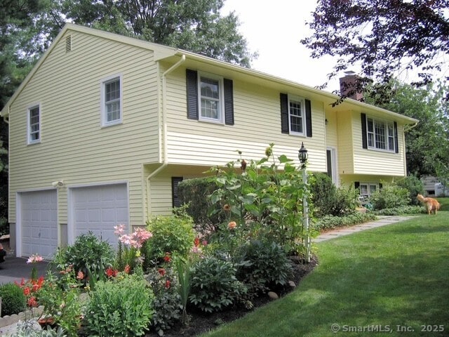 480 Budding Ridge Rd, Cheshire, CT 06410 - view of front facade featuring a garage, a front yard, driveway, and a chimney