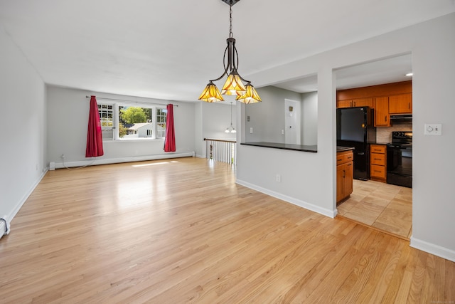 480 Budding Ridge Rd, Cheshire, CT 06410 - kitchen featuring black appliances, brown cabinets, dark countertops, light wood-style floors, and open floor plan