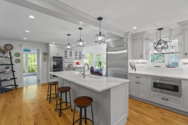 4 Johnny Cake Hill Rd, Old Lyme, CT 06371 - kitchen with built in appliances, recessed lighting, a chandelier, plenty of natural light, and a breakfast bar