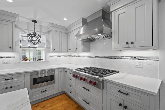 4 Johnny Cake Hill Rd, Old Lyme, CT 06371 - kitchen with wall chimney range hood, appliances with stainless steel finishes, backsplash, hanging light fixtures, and recessed lighting